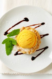 Mini Sbrisolona cookie with scoop of yellow ice cream
