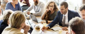 Business people around a table in the meeting space