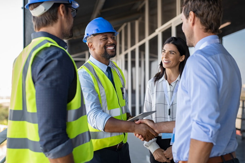 Construction workers talking to clients